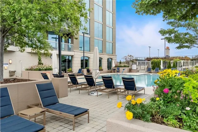 a view of a patio with couches table and chairs and potted plants