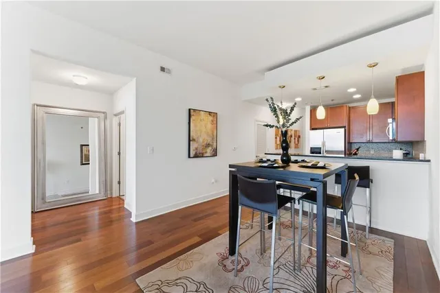 a view of a dining room with furniture and wooden floor