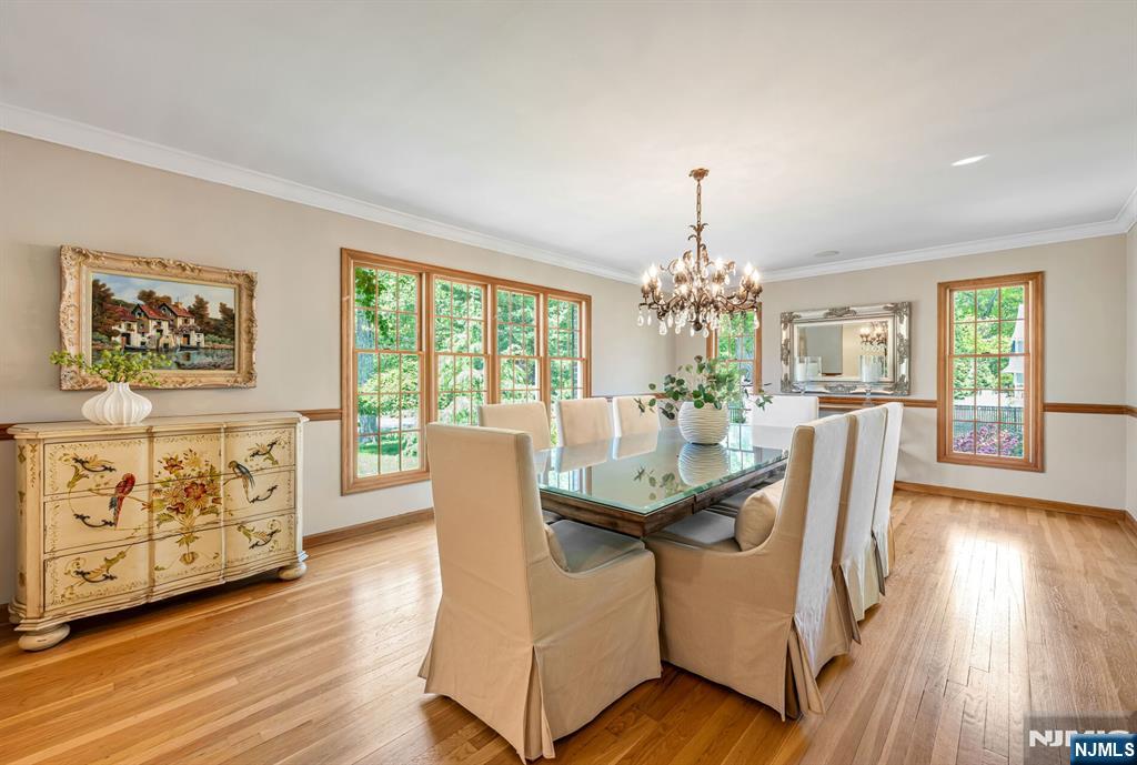 411 Snyder Road Wyckoff, NJ 07481 - Photo 6 of 36 a dining room with furniture potted plants and wooden floor