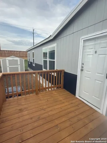 a view of a house with wooden deck