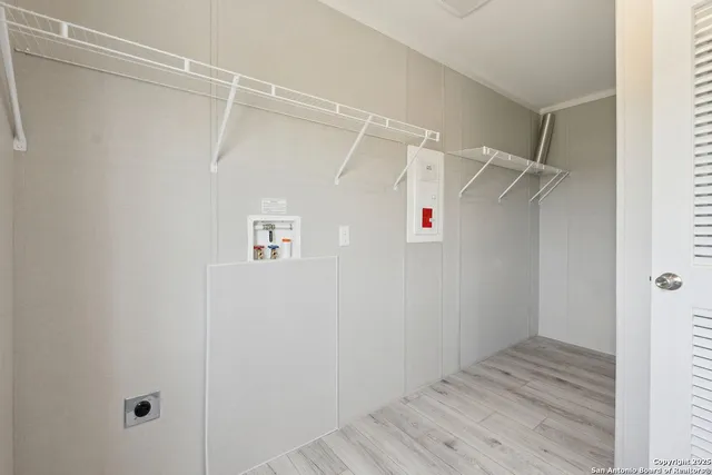 a view of walk in closet with empty racks