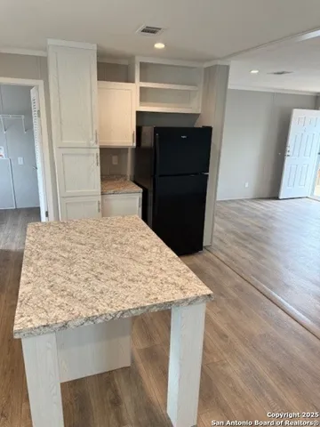 a kitchen with kitchen island sink refrigerator and stove