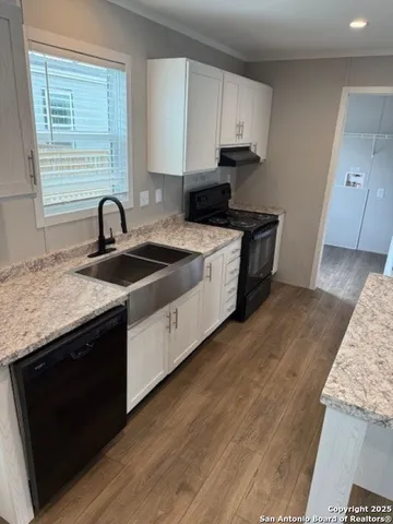a kitchen with a sink and a stove top oven