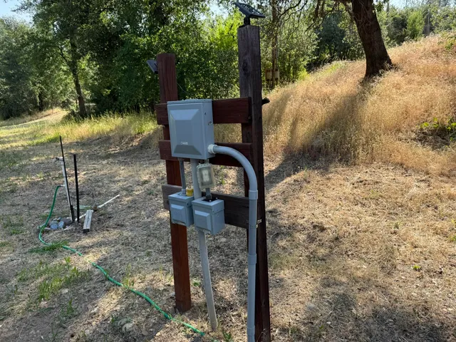 a view of a yard with iron fence