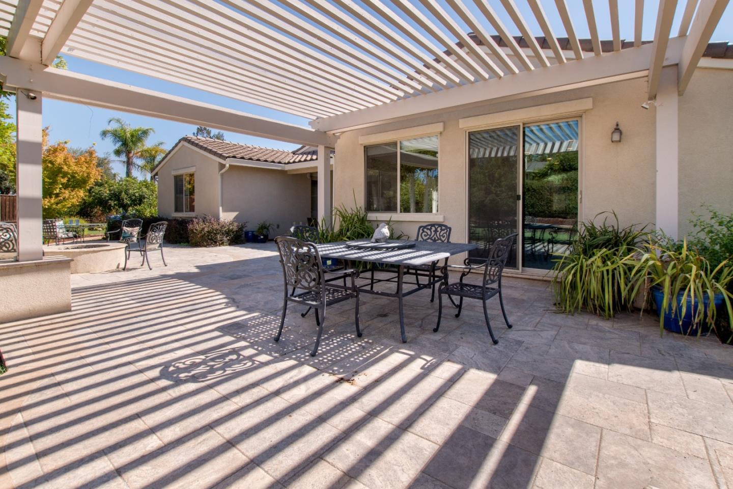 1655 Martinez Way Morgan Hill, CA 95037 - Photo 16 of 40 a view of a patio with table and chairs with wooden floor and plants