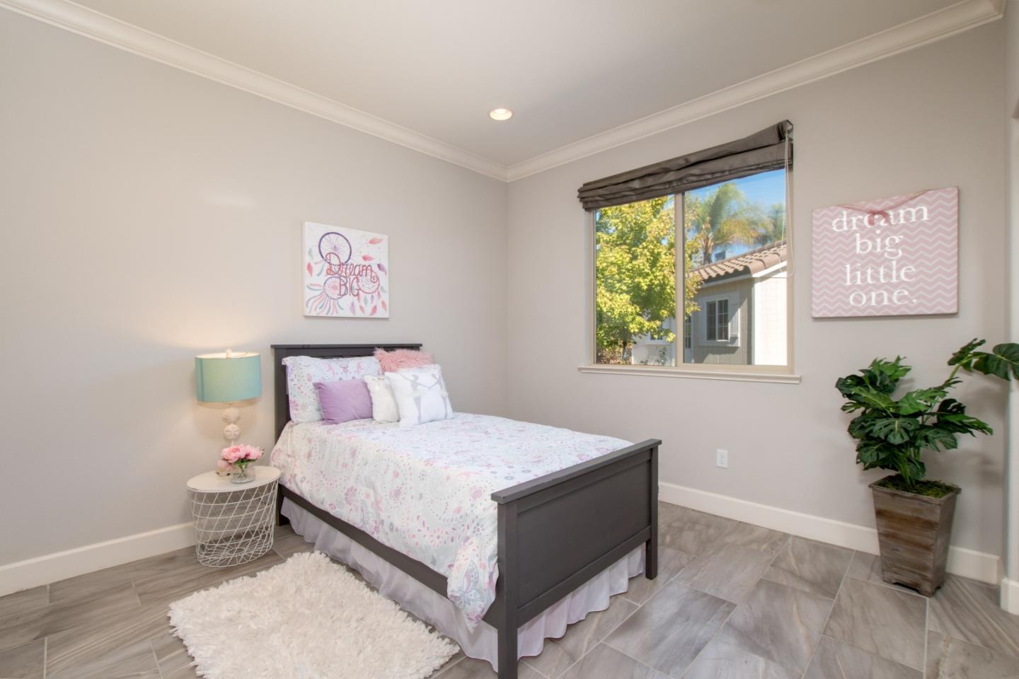 1655 Martinez Way Morgan Hill, CA 95037 - Photo 30 of 40 a bedroom with a bed and a potted plant