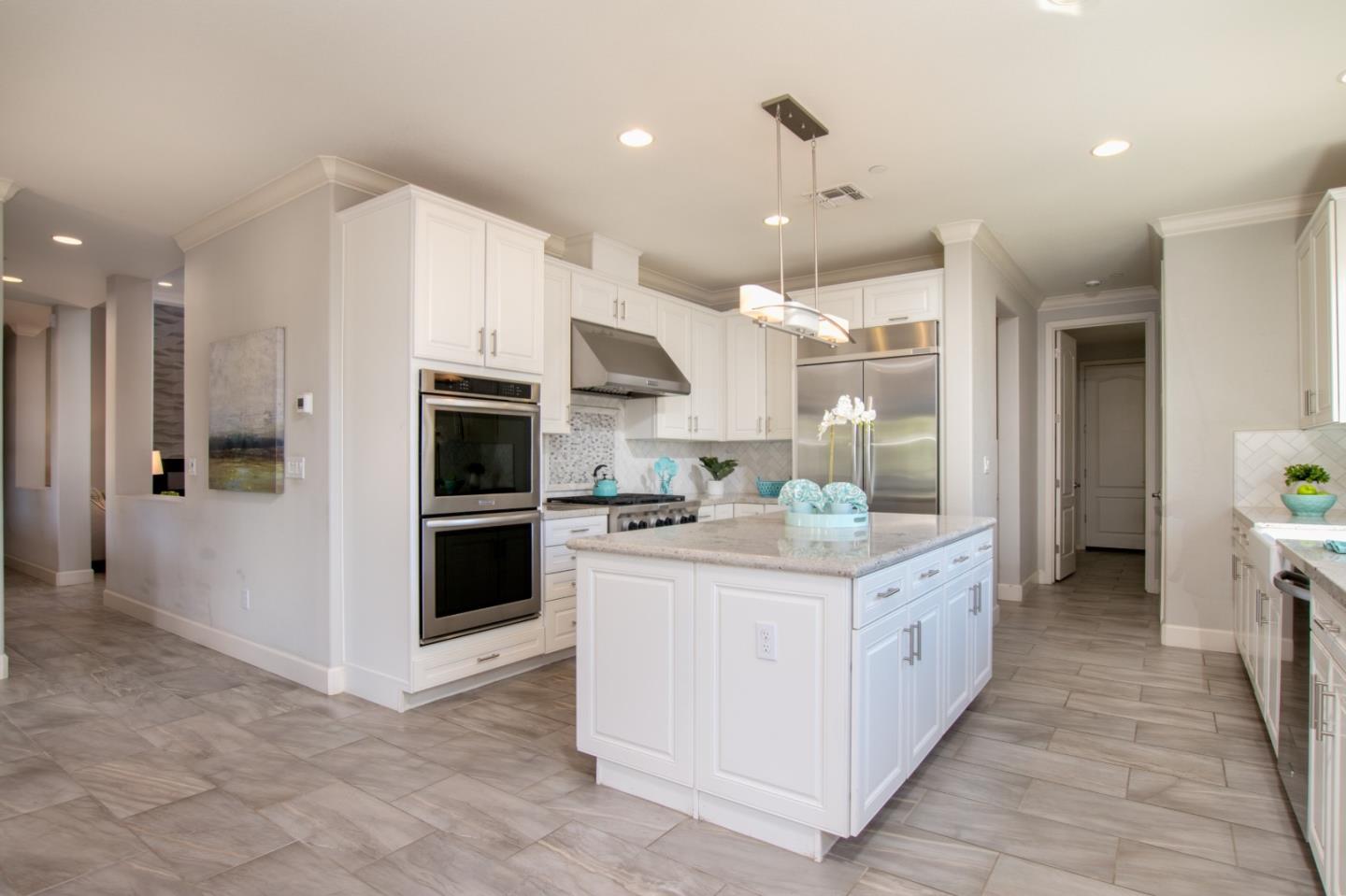 1655 Martinez Way Morgan Hill, CA 95037 - Photo 33 of 40 a kitchen with kitchen island granite countertop a sink and a stove top oven