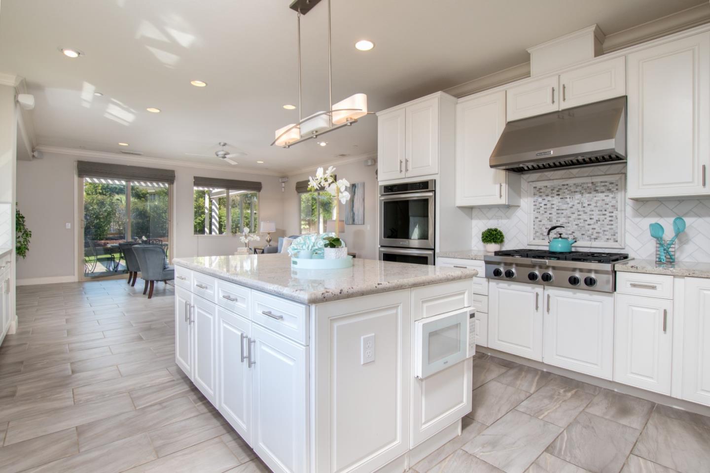 1655 Martinez Way Morgan Hill, CA 95037 - Photo 34 of 40 a kitchen with stainless steel appliances kitchen island granite countertop a sink and cabinets