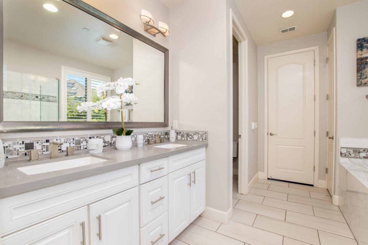 1655 Martinez Way Morgan Hill, CA 95037 - Photo 36 of 40 a bathroom with a double vanity sink and a mirror