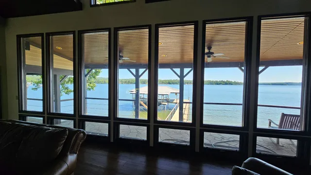 a view of empty room with window and wooden floor