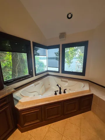 a bathroom with a bathtub and a window