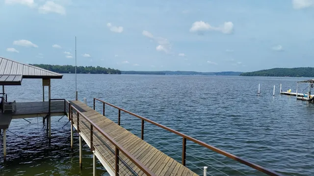 a view of balcony with wooden floor and lake view