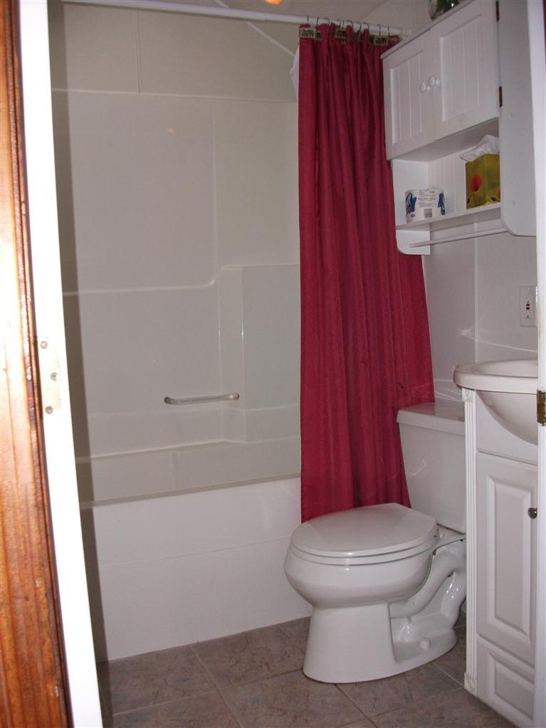 17 Beach Hills Road Dennis, MA 02639 - Photo 12 of 16 a bathroom with a toilet and a shower curtain