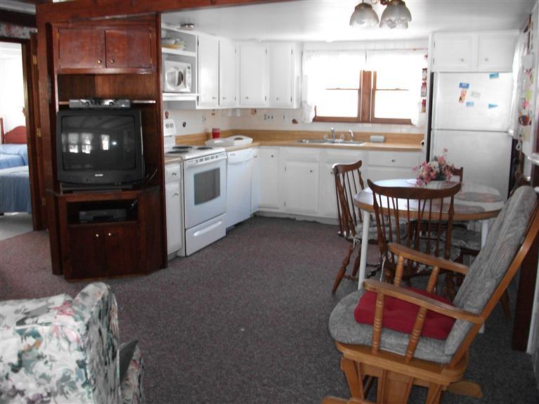 17 Beach Hills Road Dennis, MA 02639 - Photo 14 of 16 a kitchen with stainless steel appliances kitchen island granite countertop a dining table chairs and a refrigerator
