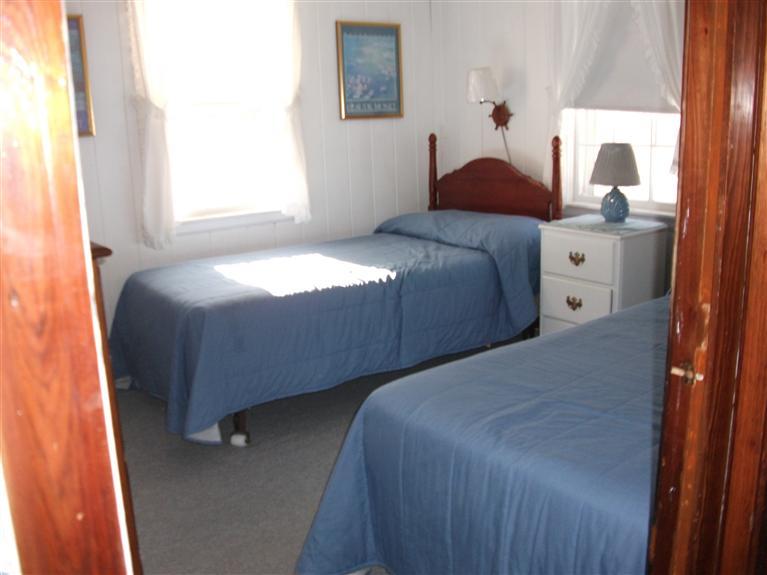 17 Beach Hills Road Dennis, MA 02639 - Photo 7 of 16 a bedroom with a bed and a window