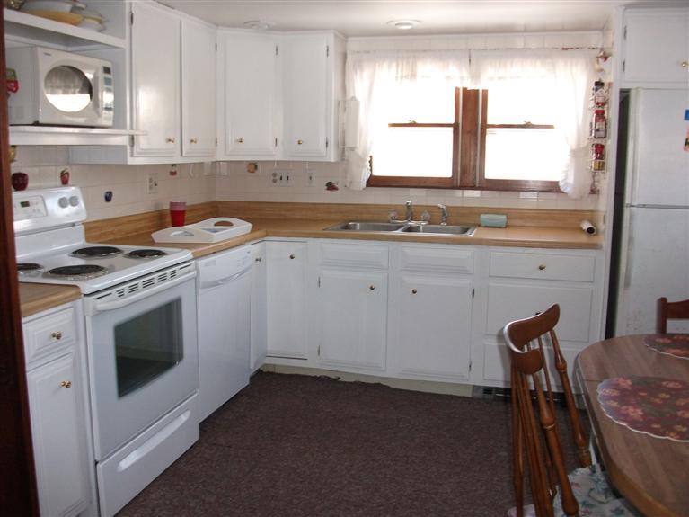 17 Beach Hills Road Dennis, MA 02639 - Photo 9 of 16 a kitchen with stainless steel appliances granite countertop a stove a sink and a refrigerator