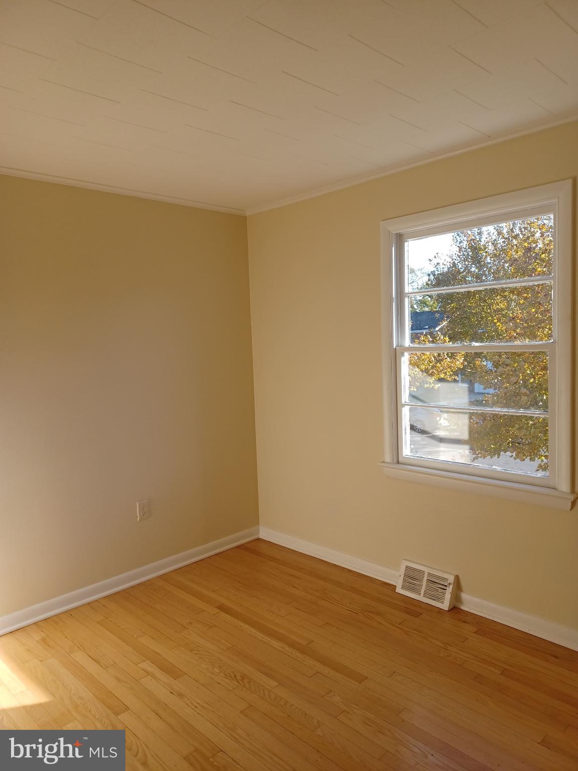 202 East Whitlock Avenue Winchester, VA 22601 - Photo 7 of 8 a view of an empty room with wooden floor and a window