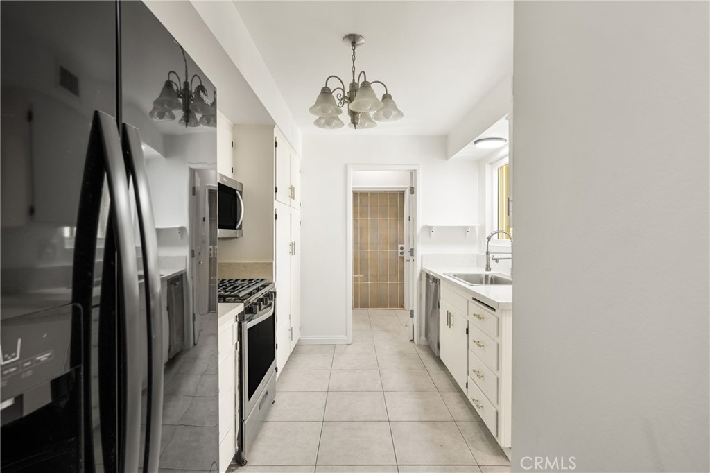96 Seton Road Irvine, CA 92612 - Photo 21 of 51 a kitchen with stainless steel appliances granite countertop a refrigerator and a sink