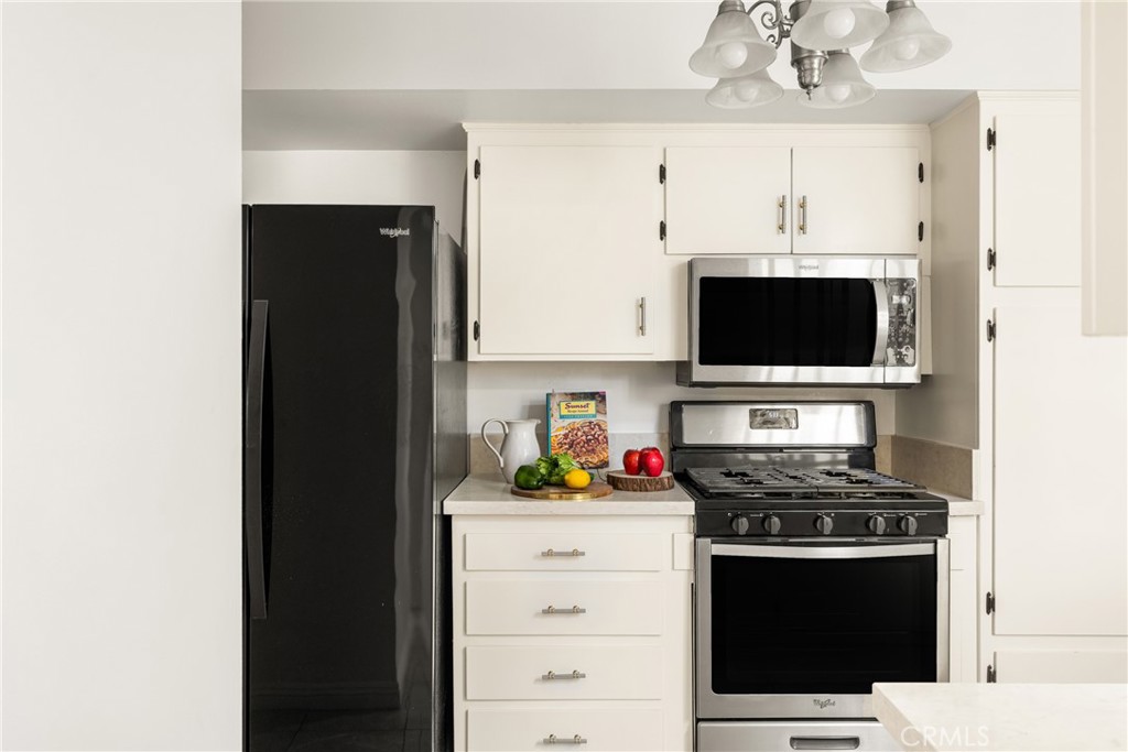 96 Seton Road Irvine, CA 92612 - Photo 23 of 51 a kitchen with stainless steel appliances a white cabinets and a stove top oven