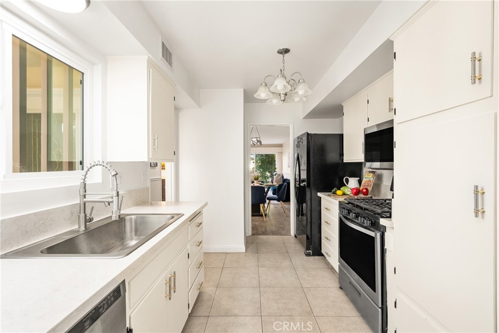 96 Seton Road Irvine, CA 92612 - Photo 26 of 51 a kitchen with stainless steel appliances granite countertop a sink and a refrigerator