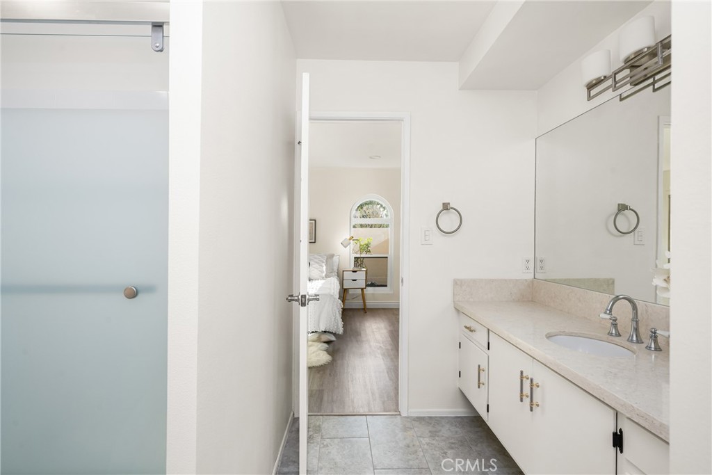 96 Seton Road Irvine, CA 92612 - Photo 39 of 51 a spacious bathroom with a granite countertop sink a mirror and a shower