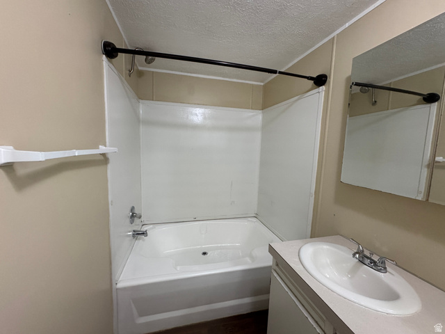 2491 Highway 89, Unit 315 Pleasant View, UT 84404 - Photo 14 of 34 Bathroom featuring a white bathtub, shower surround, and a sink vanity with an integrated basin