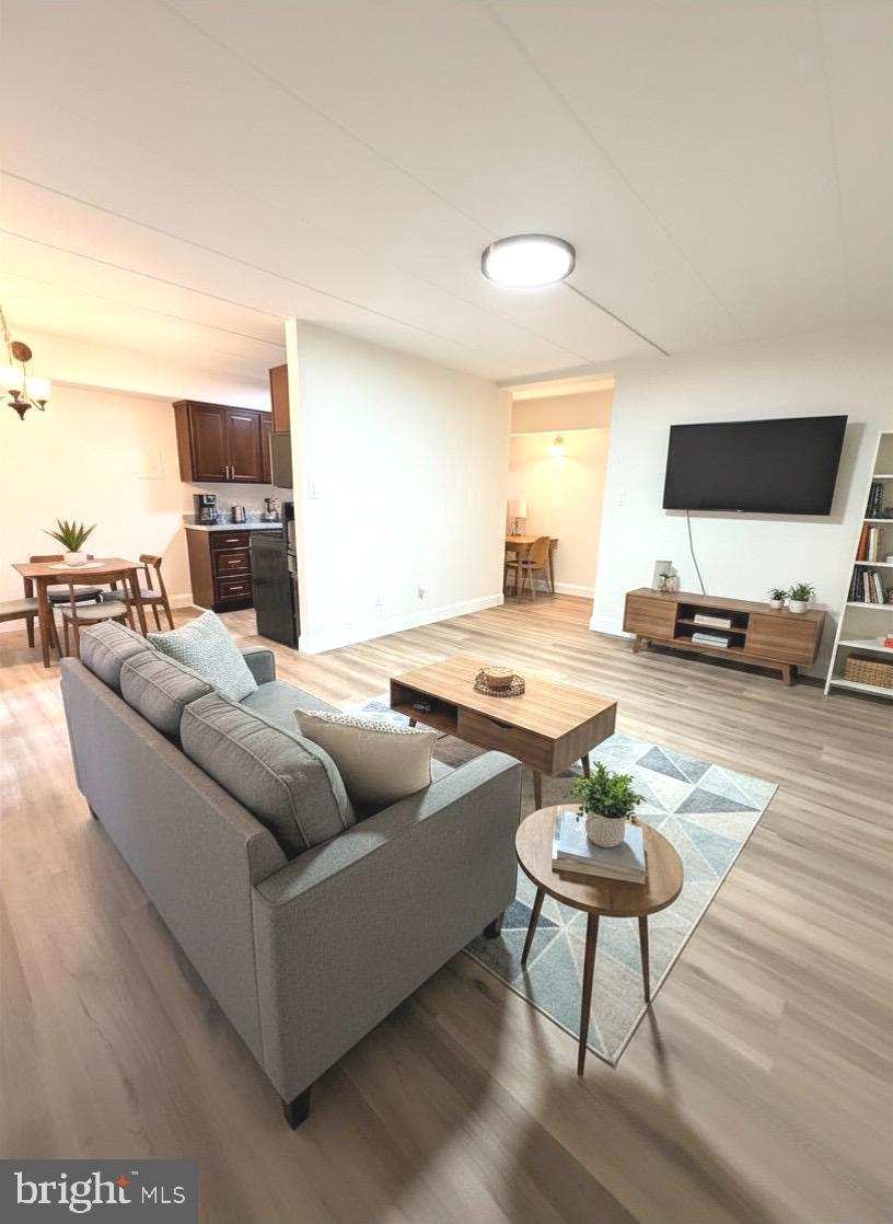 2316 Freetown Court, Unit 1B Reston, VA 20191 - Photo 16 of 36 a living room with furniture and a flat screen tv