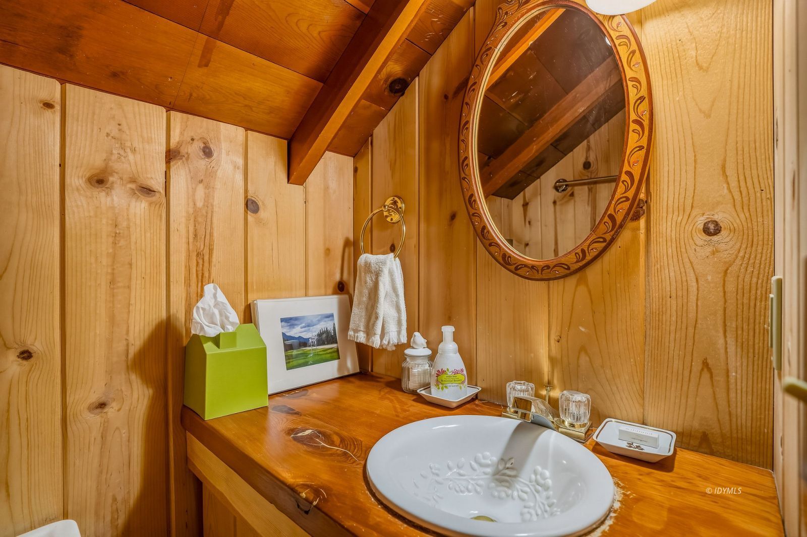 24945 Marion Ridge Drive Idyllwild, CA 92549 - Photo 29 of 53 a bathroom with a sink a mirror and a shower curtain