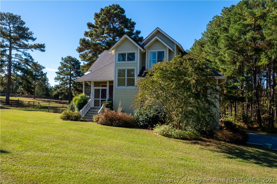 Undisclosed Address Aberdeen, NC 28315 - Photo 1 of 33 a view of a house with swimming pool next to a yard