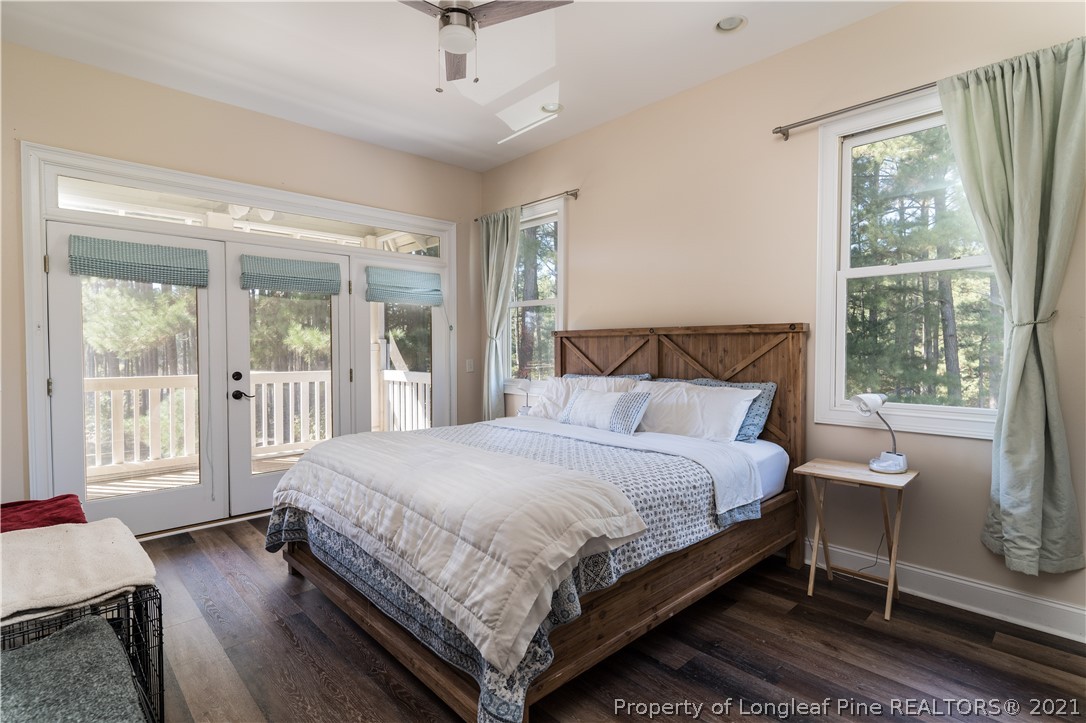 Undisclosed Address Aberdeen, NC 28315 - Photo 15 of 33 a large bedroom with a bed and wooden floor