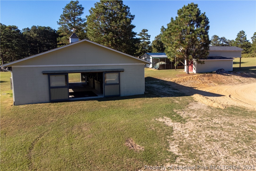 Undisclosed Address Aberdeen, NC 28315 - Photo 26 of 33 a front view of a house with a yard and garage