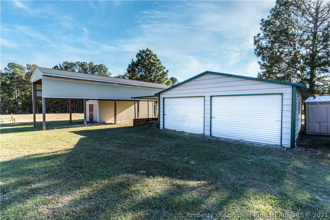 Undisclosed Address Aberdeen, NC 28315 - Photo 32 of 33 a view of a house with backyard and a tree