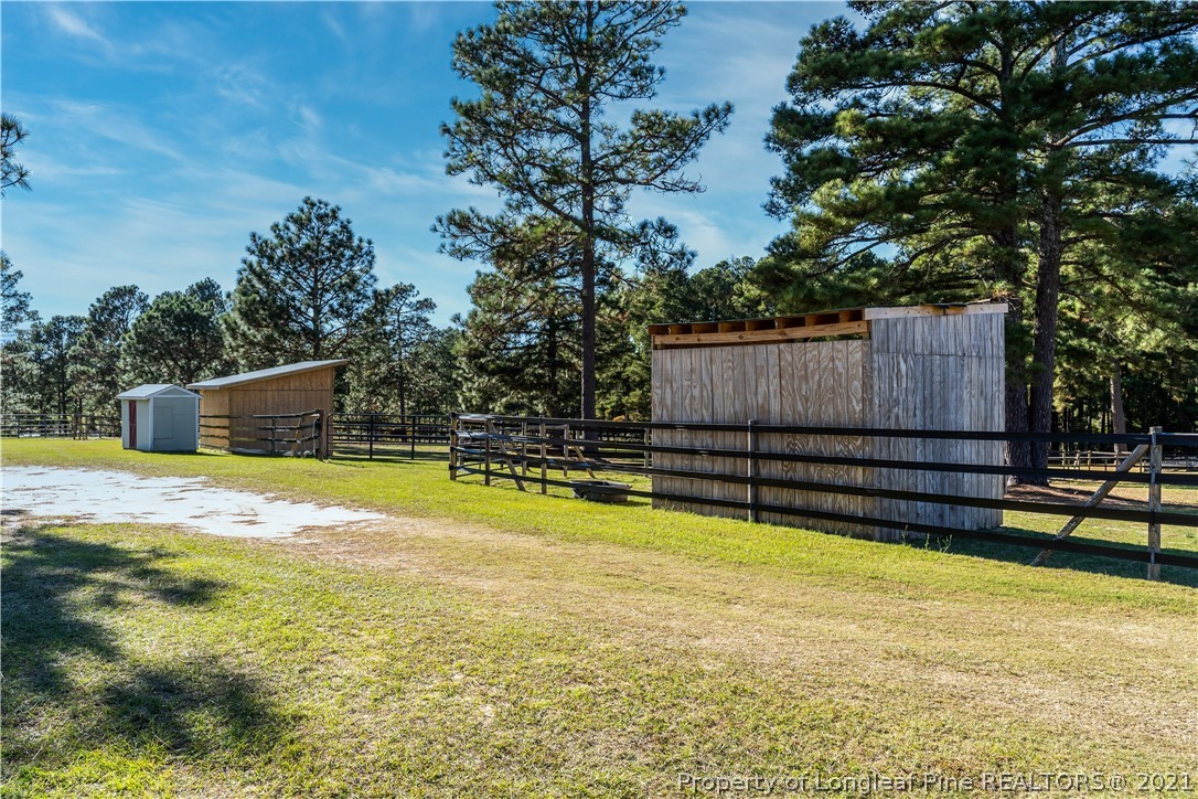 Undisclosed Address Aberdeen, NC 28315 - Photo 6 of 33 a view of a swimming pool with a bench and trees