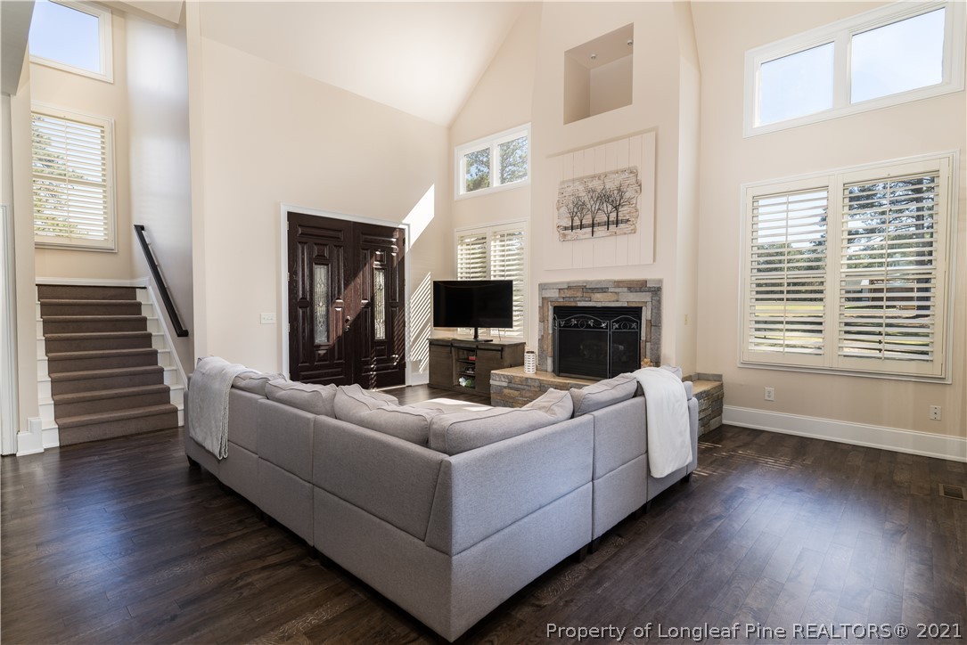Undisclosed Address Aberdeen, NC 28315 - Photo 8 of 33 a living room with furniture a flat screen tv and a fireplace