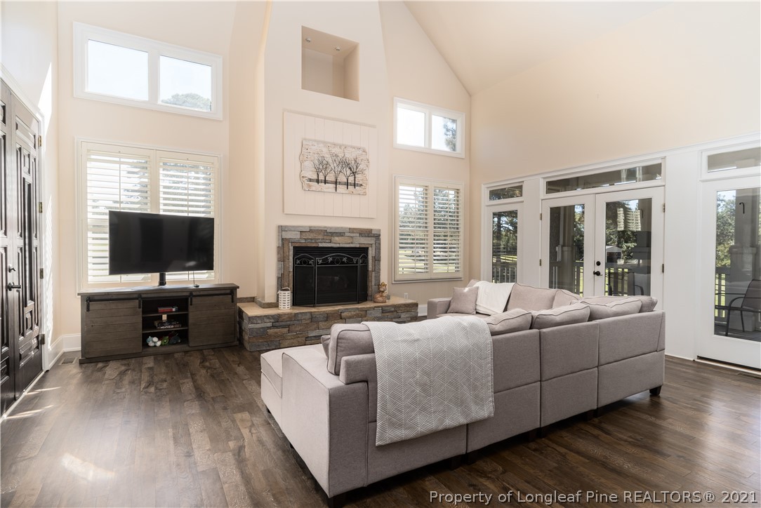 Undisclosed Address Aberdeen, NC 28315 - Photo 9 of 33 a living room with furniture a flat screen tv and a fireplace