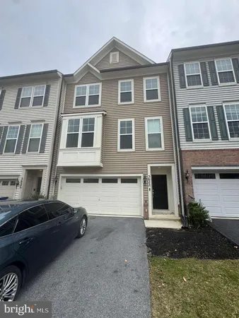 a front view of a residential apartment building with a yard