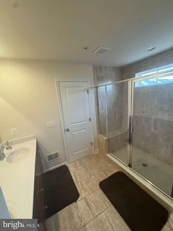 a bathroom with a sink and a shower