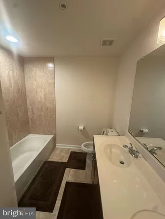 a bathroom with a sink a toilet and a bathtub