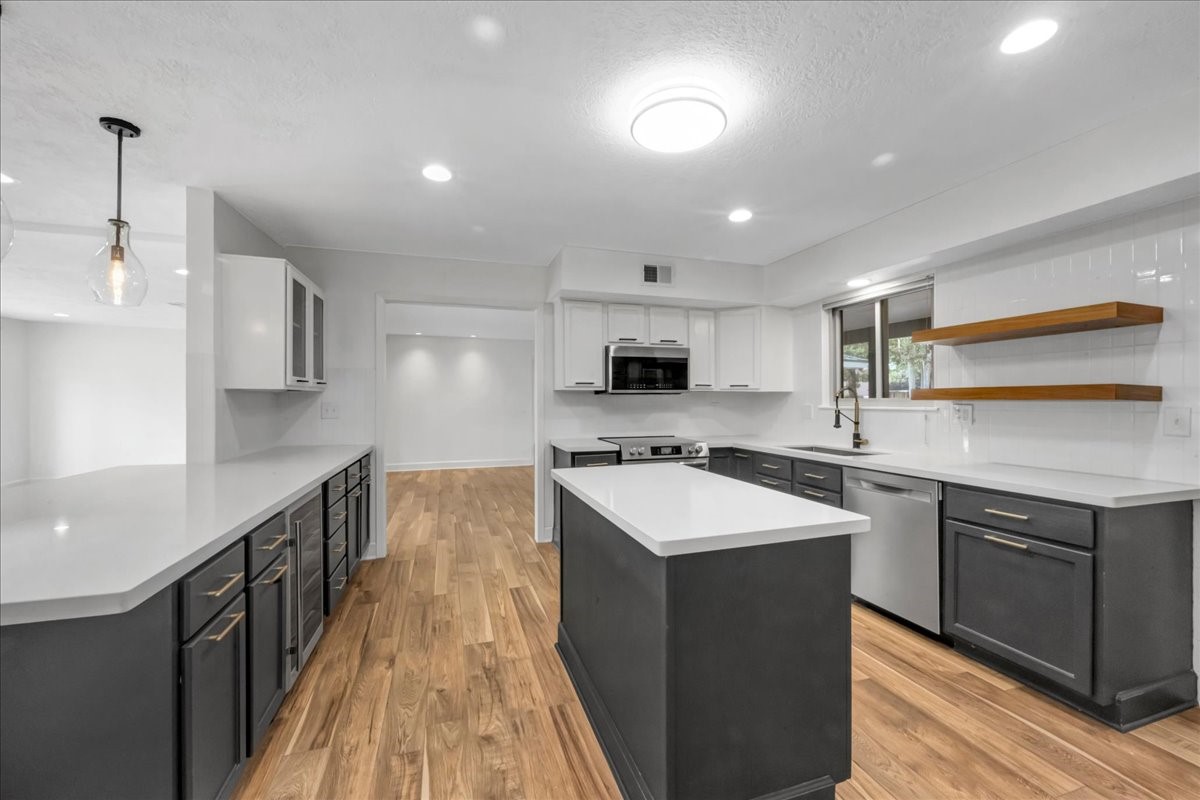 1614 Wavecrest Lane Houston, TX 77062 - Photo 14 of 42 Gorgeous functional kitchen with lots of counterspace and open concept to the family room (to the left)