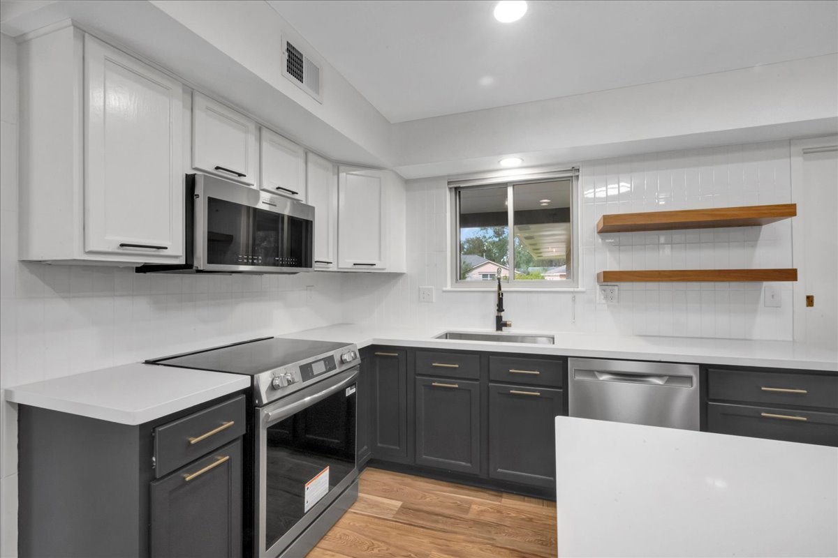1614 Wavecrest Lane Houston, TX 77062 - Photo 17 of 42 Recently updated kitchen with newly replaced Stainless Steel appliances and faucet.