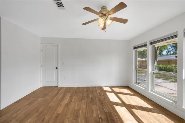 wooden floor in an empty room with a window