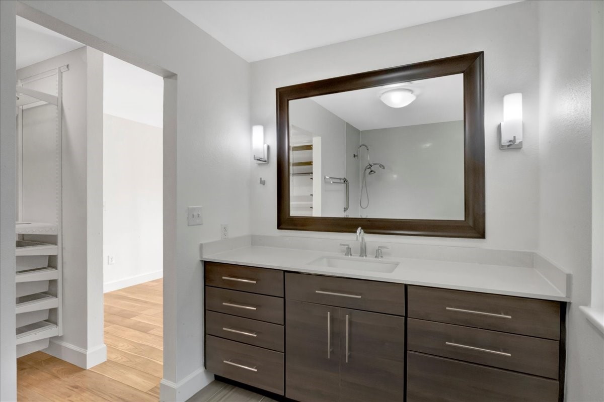 1614 Wavecrest Lane Houston, TX 77062 - Photo 22 of 42 Gorgeously updated primary bath with large framed mirror. The spacious walk-in closet is llocated between the primary bath and bedroom.