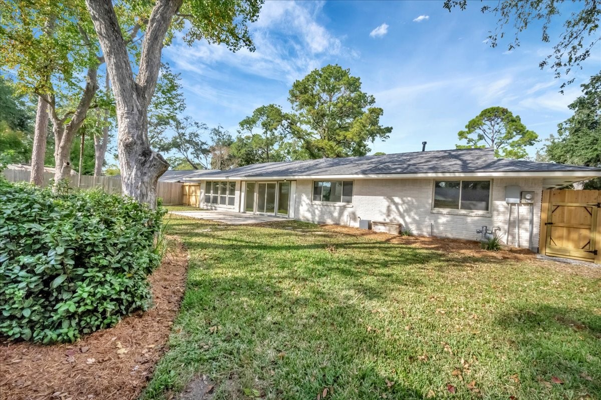 1614 Wavecrest Lane Houston, TX 77062 - Photo 34 of 42 Backyard with back patio. Recent fencing in many portions including newly rebuilt gate.