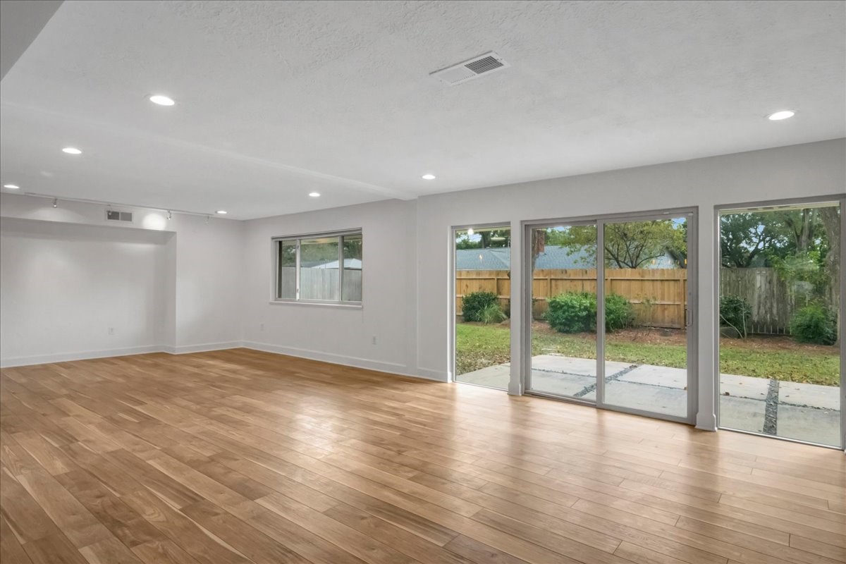 1614 Wavecrest Lane Houston, TX 77062 - Photo 9 of 42 Large open space for family room / living room has lots of natural light and a patio door to the back.