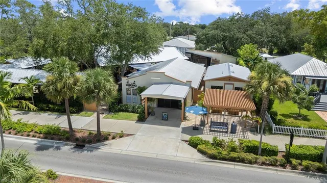 an aerial view of a house with garden space and street view