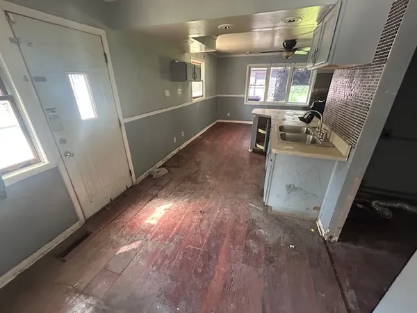 a view of hallway with furniture and wooden floor