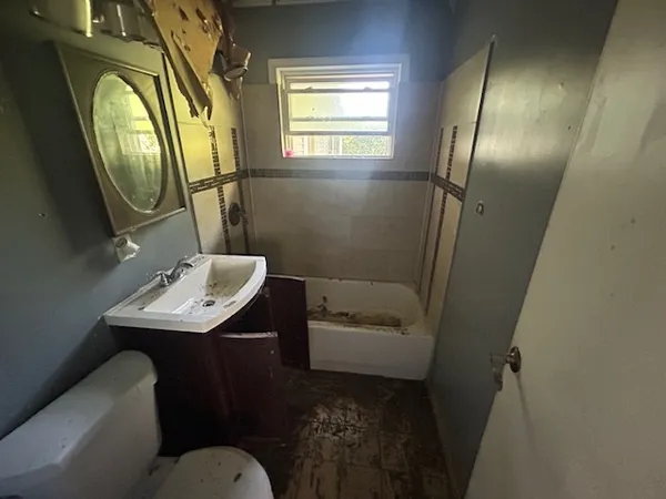 a bathroom with a sink toilet and a mirror
