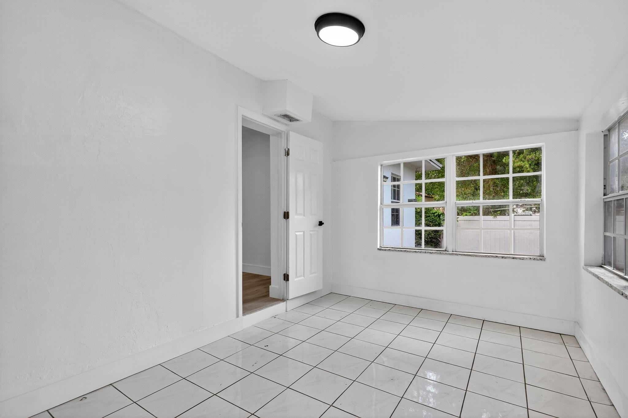 40 Northwest 68th Street Miami, FL 33150 - Photo 21 of 27 an empty room with windows