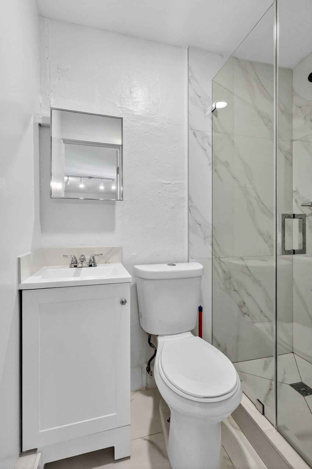 40 Northwest 68th Street Miami, FL 33150 - Photo 4 of 27 a bathroom with a sink a toilet and shower