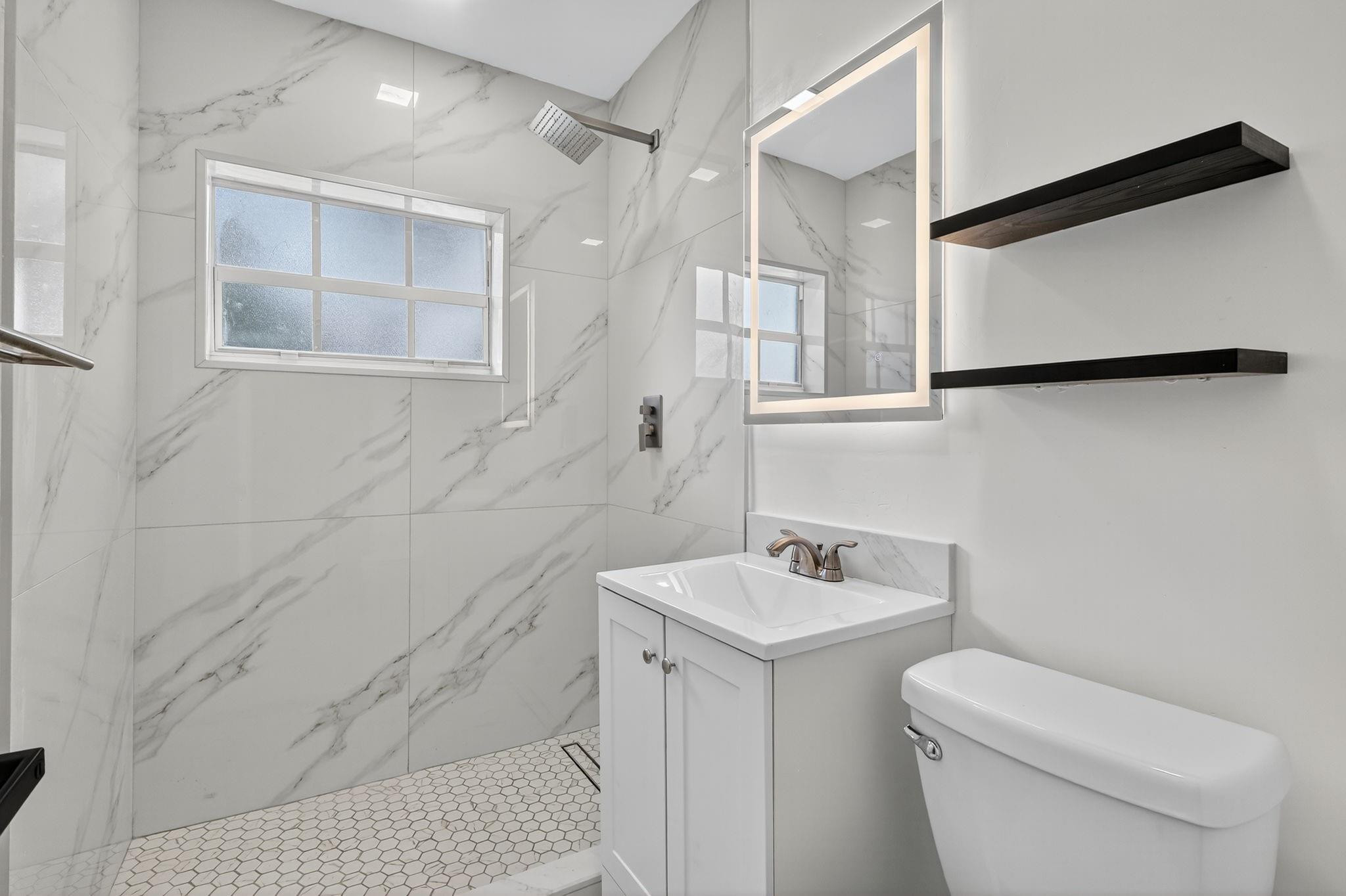 40 Northwest 68th Street Miami, FL 33150 - Photo 8 of 27 a bathroom with a sink a toilet and shower